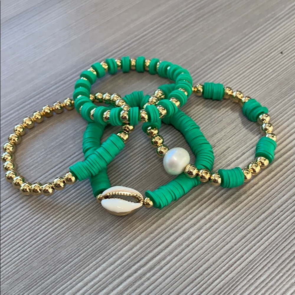 Cutest set in green bracelets worn pearls .